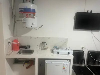 a small kitchen with a sink and a microwave at studios in Cordoba in Cordoba