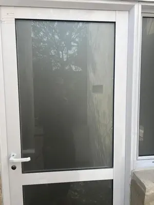 a glass door with a reflection of a tree at studios in Cordoba in Cordoba