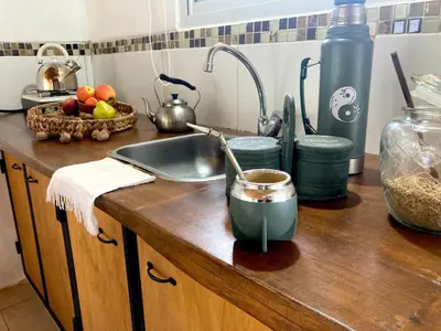 a kitchen counter with a sink and a bowl of food at Cabañas Yin y Yang in Pueblito