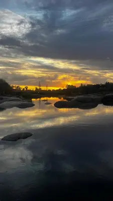 a large body of water with a sunset in the background at Casa Campo Cordoba Cabalango in Cavalango