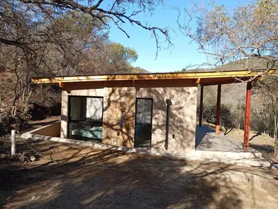 a small building with a roof on top of it at Cabaña VenTeVeo Chakra de Montaña in Atos Pampa
