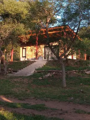 a building with a pathway in front of it at Cabaña VenTeVeo Chakra de Montaña in Atos Pampa