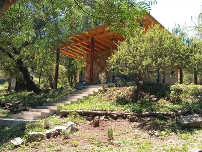 a house with stairs leading up to it at Cabaña VenTeVeo Chakra de Montaña in Atos Pampa
