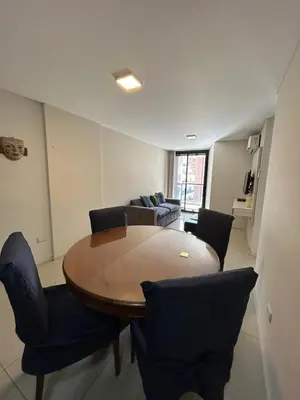 a living room with a wooden table and chairs at Departamento -Peredo- 2 cuadras de plaza España-Cuidad universitaria By Apartcba in Cordoba