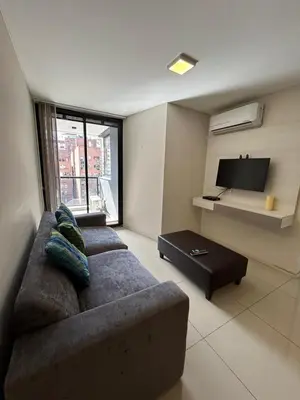a living room with a couch and a tv at Departamento -Peredo- 2 cuadras de plaza España-Cuidad universitaria By Apartcba in Cordoba