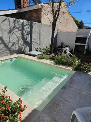 a swimming pool in the backyard of a house at CASA TILO con pileta exclusiva in Mina Clavero