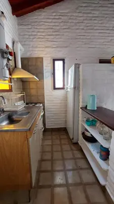a small kitchen with a sink and a refrigerator at CASA TILO con pileta exclusiva in Mina Clavero