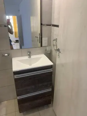 a bathroom with a sink and a mirror at Casa Playas De Oro in Villa Independencia