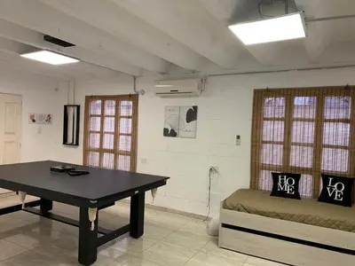 a room with a table and a bed in it at Casa Playas De Oro in Villa Independencia