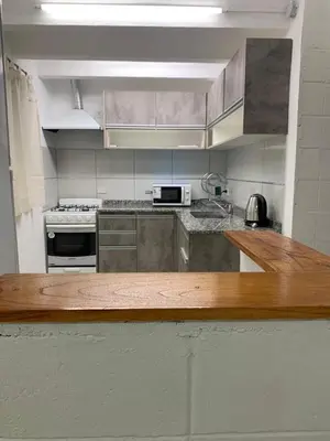a kitchen with stainless steel appliances and a wooden counter top at Casa Playas De Oro in Villa Independencia