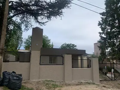 a house with a fence in front of it at Casa Playas De Oro in Villa Independencia