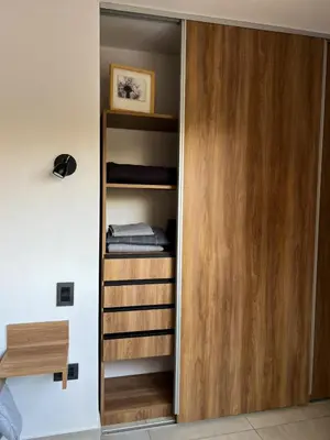 a room with a closet with wooden shelves at JC Apart 2 in Cordoba