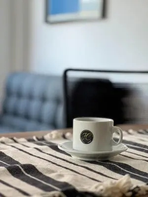 a coffee cup sitting on a table with a napkin at JC Apart 2 in Cordoba