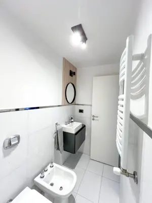 a white bathroom with a sink and a toilet at JC Apart 2 in Cordoba