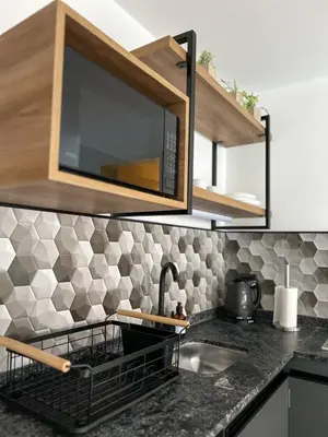 a kitchen counter with a sink and a microwave at JC Apart 2 in Cordoba