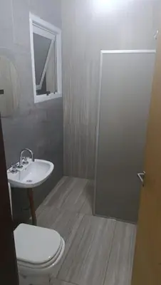 a bathroom with a sink and a toilet and a mirror at Altos de Horizonte I in Cordoba