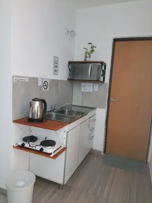 a small kitchen with a sink and a microwave at Altos de Horizonte I in Cordoba