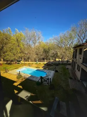 a backyard with a swimming pool and a house at Flusshaus8 in Villa General Belgrano