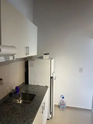 a kitchen with a sink and a refrigerator at Flusshaus8 in Villa General Belgrano