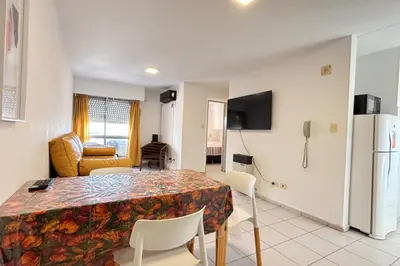 a kitchen and dining room with a table and a refrigerator at Departamento comodo y central en Córdoba, a metros de la Cañada in Cordoba