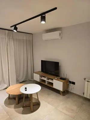 a living room with a table and a tv at Atp Bolivia 164 in Cordoba