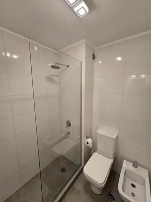 a bathroom with a toilet and a glass shower at Atp Bolivia 164 in Cordoba