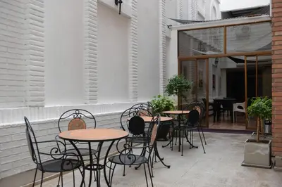 a group of tables and chairs on a patio at Santiago Hotel in Cordoba