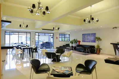 a lobby with chairs and tables and a living room at Santiago Hotel in Cordoba