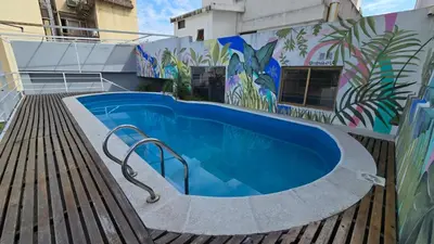 a swimming pool with a mural on the side of a building at Santiago Hotel in Cordoba