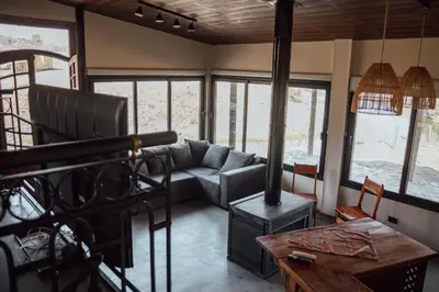a living room with a couch and a wood stove at Cabaña en Tala Cruz a 9km de Villa Cañada del Sauce in Tala Cruz