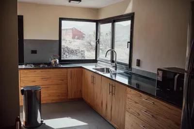 a kitchen with a sink and a large window at Cabaña en Tala Cruz a 9km de Villa Cañada del Sauce in Tala Cruz