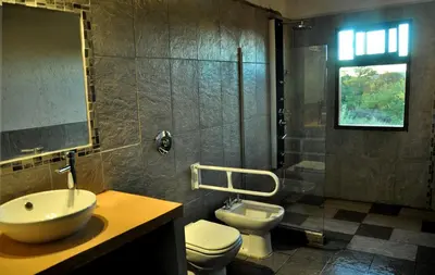 a bathroom with a sink and a toilet and a shower at Senderos del Tao in Las Rabonas