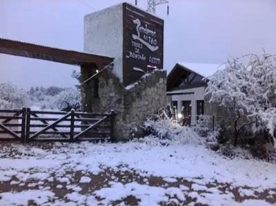 a sign for a restaurant in the snow at Senderos del Tao in Las Rabonas