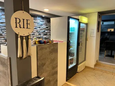 a restaurant with a re sign on the wall at Hotel Posada del Ángel in Villa Carlos Paz