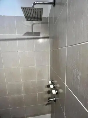 a shower with a bunch of toiletries in a bathroom at Hotel Posada del Ángel in Villa Carlos Paz