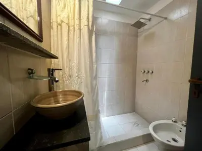 a bathroom with a shower and a toilet and a sink at Hotel Posada del Ángel in Villa Carlos Paz