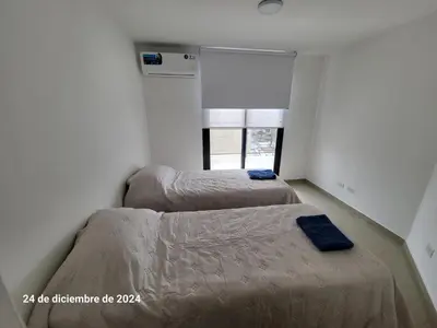 two beds in a room with a window at Calasanz Premium in Cordoba