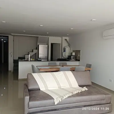 a living room with a couch and a kitchen at Calasanz Premium in Cordoba
