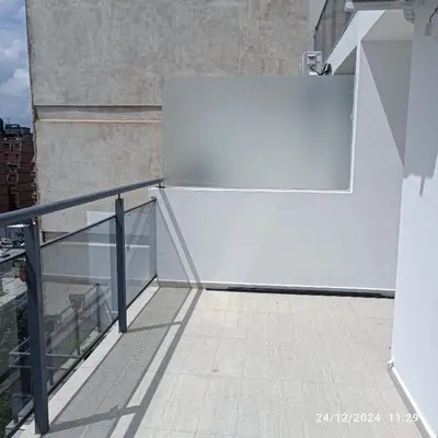 a white refrigerator sitting on top of a balcony at Calasanz Premium in Cordoba