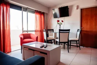 a living room with a table and chairs at Dpto 1 hab con cochera in Cordoba