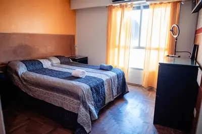 a bedroom with a bed with two towels on it at Dpto 1 hab con cochera in Cordoba