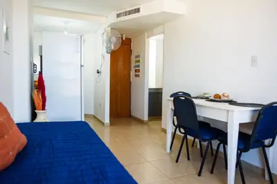 a bedroom with a bed and a table and chairs at Dpto 1 habitación con cochera in Cordoba