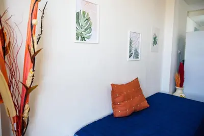 a bedroom with a blue bed with a orange pillow at Dpto 1 habitación con cochera in Cordoba