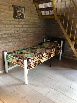 a bed in the corner of a room at Cabañas Rosarito in Villa Larca