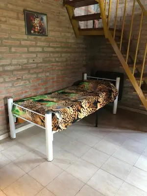 a bed in the corner of a room at Cabañas Rosarito in Villa Larca