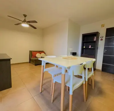 a dining table and chairs in a living room at Departamento Céntrico in Cordoba