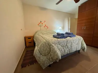 a bedroom with a bed with blue towels on it at Departamento Céntrico in Cordoba