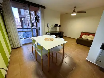 a living room with a white table and chairs at Departamento Céntrico in Cordoba