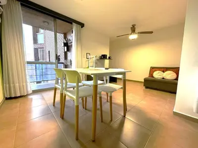 a dining room with a table and chairs and a couch at Departamento Céntrico in Cordoba