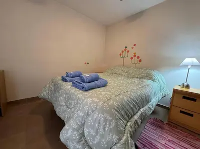 a bedroom with a bed with two blue pillows on it at Departamento Céntrico in Cordoba